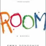 Book cover for Room by Emma Donoghue. The title ROOM is written in large, colorful childlike letters on a white background, with the author’s name and a review quote at the top.